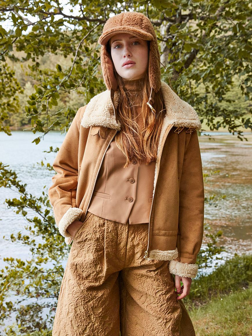 Modella indossa montone marrone.